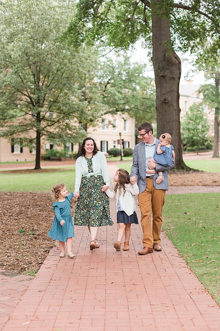 family of five walks on brick walkway at USC Horseshoe in Columbia SC